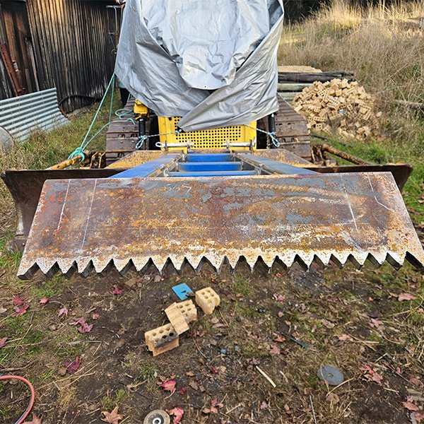 Customised tree pusher attachment for a bull dozer.