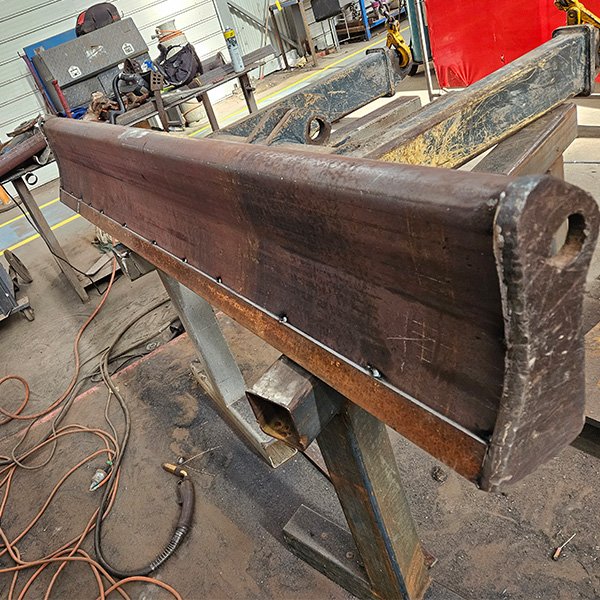 Repair to steel blade for a excavator.