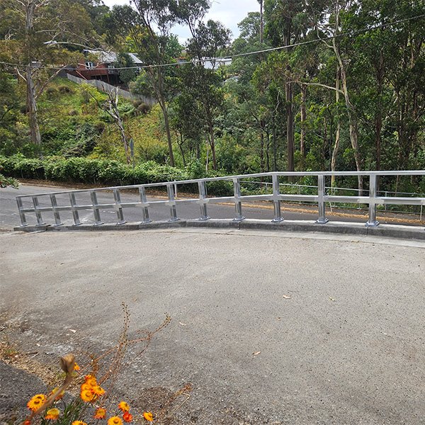 Structural steel guardrail for a driveway.
