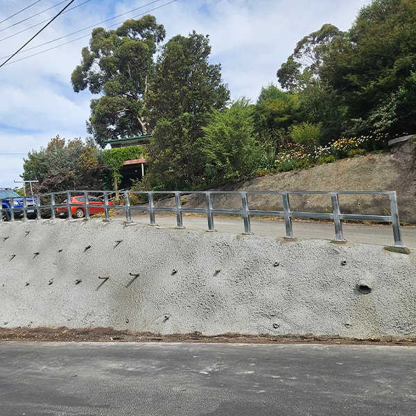 Structural steel guardrail for a driveway.