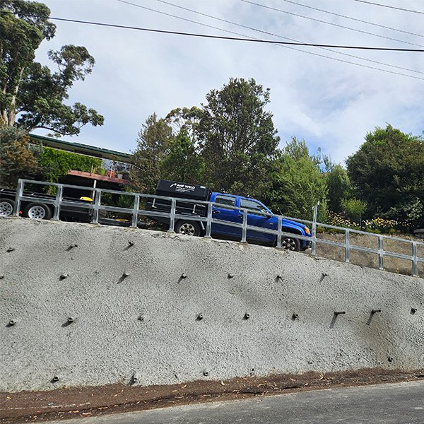 Structural steel guardrail for a driveway.