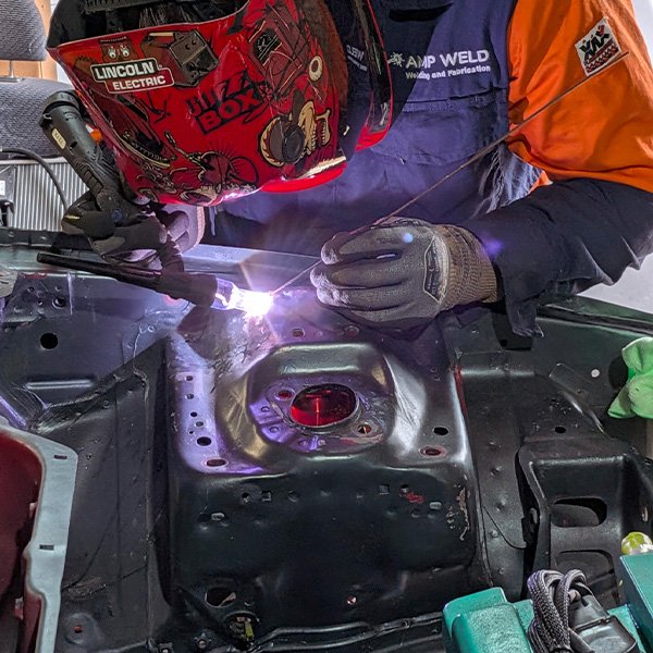 Custom fabrication on a car engine bay.